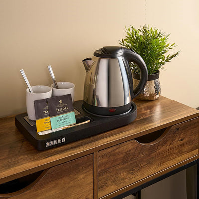 Hotel guest room kettle and welcome tray — one of the appliances in a room's daily electricity cost